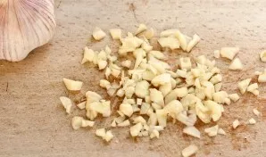 Česnaką nulupkite, smulkiai supjaustykite.